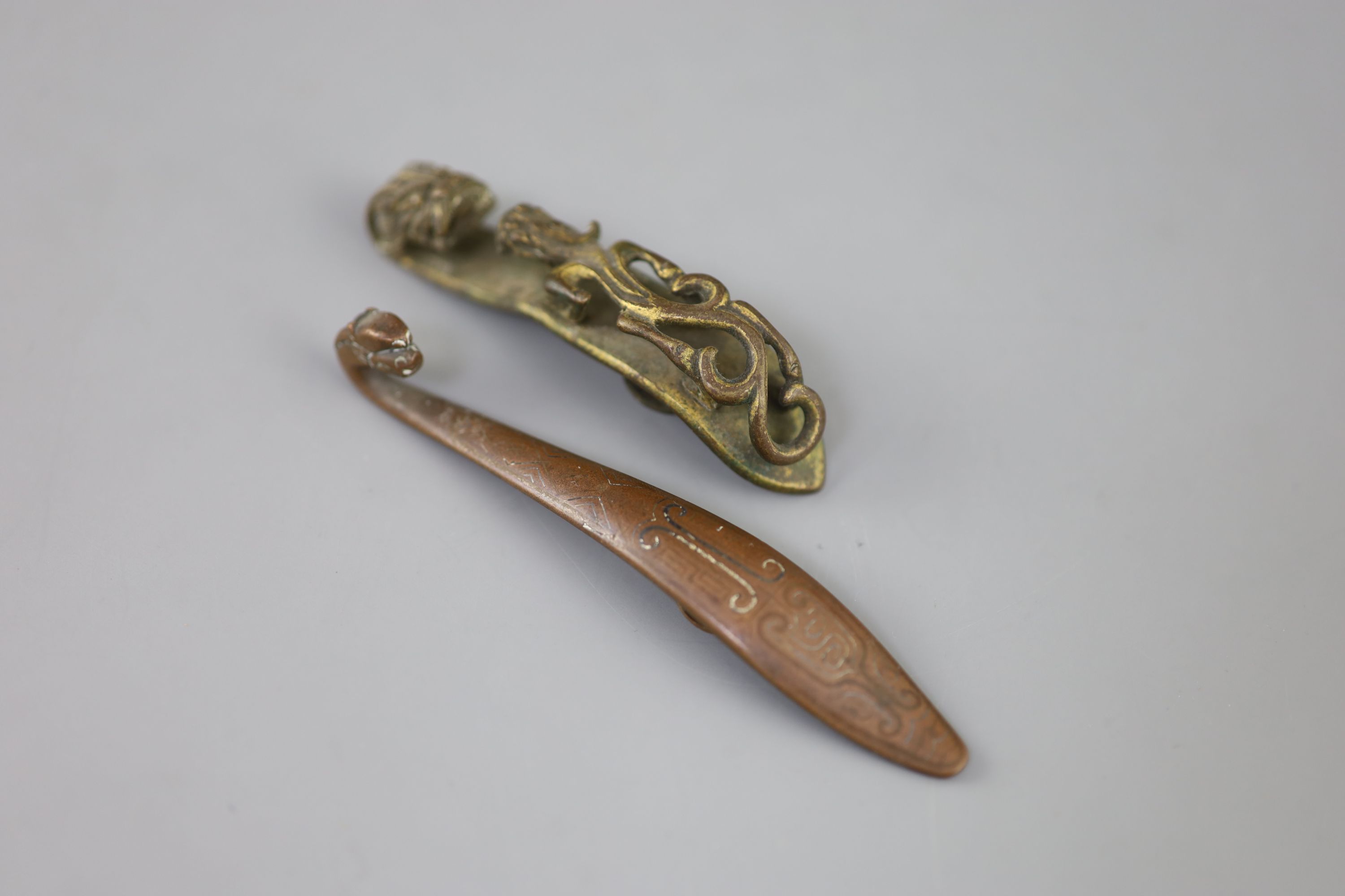 A Chinese archaistic silver and copper inlaid bronze belt hook and a bronze chilong belt hook, 18th/19th century,